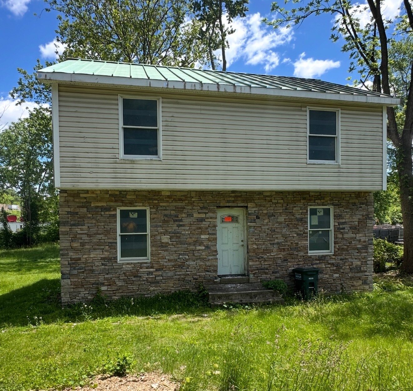 New siding & standing-seam metal roof — before